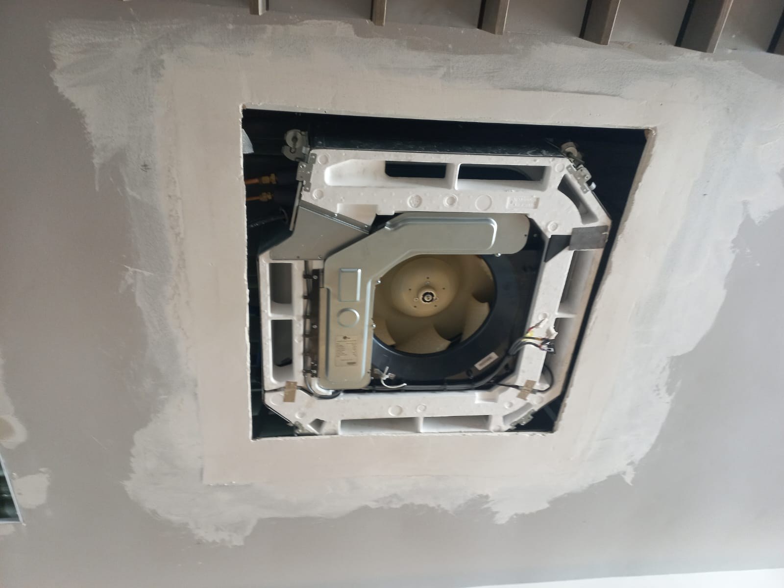 Close-up of a recessed ceiling cassette air-conditioning unit