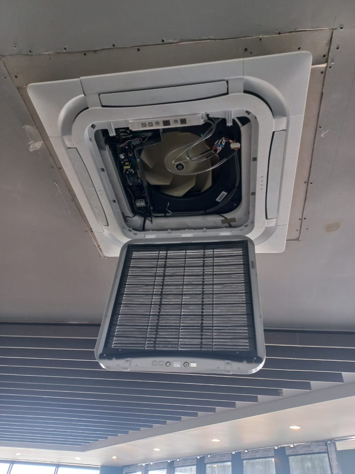 Completed ceiling cassette air-conditioning installation in an office